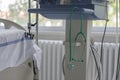 Green stethoscope hanging on medical ventilator in ICU in hospital, a place where can be treated patients with pneumonia caused by
