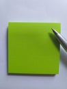 Green sticky notes and a silver pen Royalty Free Stock Photo