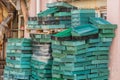 Green storage crates stacked against wall