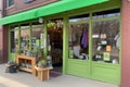 green storefront with products for sale, including eco-friendly clothing and accessories