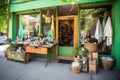 green storefront with products for sale, including eco-friendly clothing and accessories