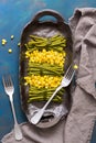 Green string beans and corn on a rustic dish. Top view, blue background. Royalty Free Stock Photo