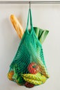 Green string shopping bag hanging on a hook in the kitchen Royalty Free Stock Photo