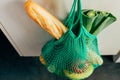 Green string shopping bag hanging on a hook in the kitchen Royalty Free Stock Photo