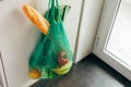 Green string shopping bag hanging on a hook in the kitchen Royalty Free Stock Photo