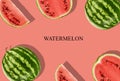 Green, striped watermelon with halves, slices, on pink background with inscription watermelon and copy space for text Royalty Free Stock Photo