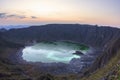 Green sulfuric lake in volcanic crater