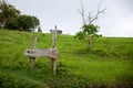 Green summer hill and wooden signpost. Cloudy day outside photo. Summer forest and hills hiking day Royalty Free Stock Photo