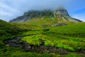 Green summer landscape, rock hill in the clouds, Svalbard, Norway
