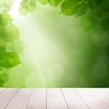 Green summer leaves and abstract bokeh light with white wooden board background