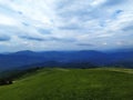 Green summer mountain landscape. Dirt road, footpath at the top of the peak.