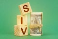 On a green surface, dollars and cubes with the inscription - SIV