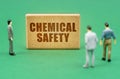 On the green surface are figures of people and a sign with the inscription - Chemical Safety Royalty Free Stock Photo