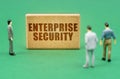 On the green surface are figures of people and a sign with the inscription - Enterprise Security
