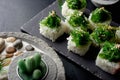 Green sushi set with chuka served on black clay plate with soy sauce and chopsticks, top view. Delicious traditional Royalty Free Stock Photo