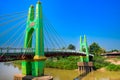 Green suspension bridge across Nan River at Chum Saeng District Royalty Free Stock Photo