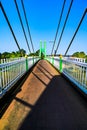 Green suspension bridge across Nan River at Chum Saeng District Royalty Free Stock Photo