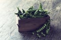 Green sweet peas in wooden box on brown wood surface Royalty Free Stock Photo