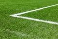 Green synthetic artificial grass soccer sports field with white corner stripe line Royalty Free Stock Photo