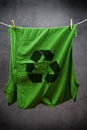 Green t shirt with recycle symbol hanging on rope to dry Royalty Free Stock Photo