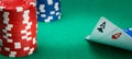 On the green table, for gambling, two ace cards are parted, on the left is a stack of chips, for playing in a casino, there is a Royalty Free Stock Photo