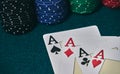 on the green table, highlights a set of four aces, in poker game next to the colored chips Royalty Free Stock Photo