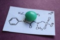 Green tablet of Metamizole sodium or Analgin with it chemical formula.