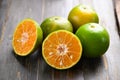 Green tangerine orange fruit on wooden background