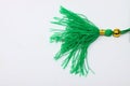 Green tassel on a white isolated background