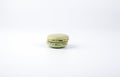 Green tasty macaroon on white background