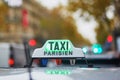 Green taxi sign in Paris