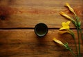 Green tea bowl on a dark brown wooden background with beautiful yellow lilies Royalty Free Stock Photo