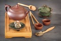 Green tea buds, ceramic teapot, cups, wooden tea tray and other attributes for tea ceremony Royalty Free Stock Photo