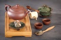 Green tea buds, ceramic teapot, cups, wooden tea tray and other attributes for tea ceremony Royalty Free Stock Photo