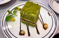 Green tea cake with chocolate, decorated in a white plate Royalty Free Stock Photo