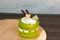 Green tea cake placed on a wooden plate Royalty Free Stock Photo