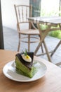 Green tea cheesecake - A plate of homemade matcha cheesecake topped with whipped cream cheese on table background. Japanese Matcha Royalty Free Stock Photo