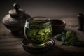 Green tea in a cup and leaves on the table. Glass mug. Royalty Free Stock Photo