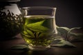 Green tea in a cup and leaves on the table. Glass mug. Royalty Free Stock Photo