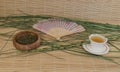 Green tea in a Cup, outdoor fan on bamboo Mat Royalty Free Stock Photo