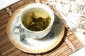 Green tea in a cup with a tea leafs Royalty Free Stock Photo