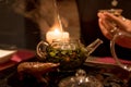 Green tea, glass teapot with tea leaves, tea is poured into a cup at a tea ceremony Royalty Free Stock Photo