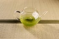 Green tea in a glass teapot on Tatami Mat