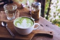 Green tea hot drink latte white cup on wood table aroma relax time in coffee shop Royalty Free Stock Photo