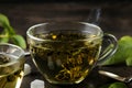 Green tea. Hot tea in a cup, sugar and mint on a dark background Royalty Free Stock Photo