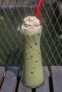 Green tea iced with whipped cream set on the table ready to serve. Royalty Free Stock Photo