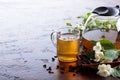 Green tea with jasmine in cup and teapot on old copper table. Royalty Free Stock Photo