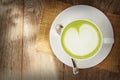 Green tea latte on wood background