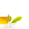 Green tea leaf and glass cup of black tea Royalty Free Stock Photo