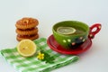 Green tea with lemon, cookies, yellow flower